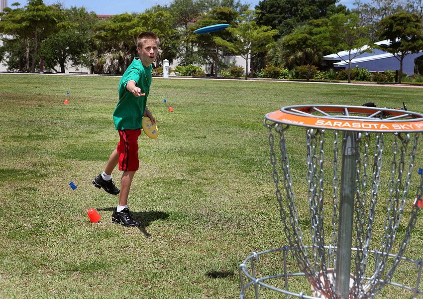Miles Perkins, 12, tries his hand at disc golf, Saturday, June 16, during the Sarasota Sports Festival at Payne Park.