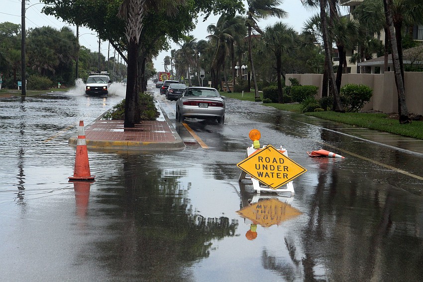 A portion of Beach Road near Siesta Key Public Beach was under water, yet cars still attempted to drive through the water.