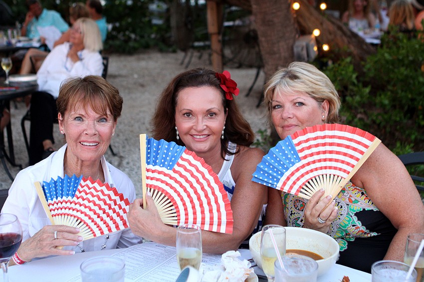 Dee Keenan, Chris Meyers and Margaret Wallace show off their American flag fans, Monday, July 2, at Mar Vista.