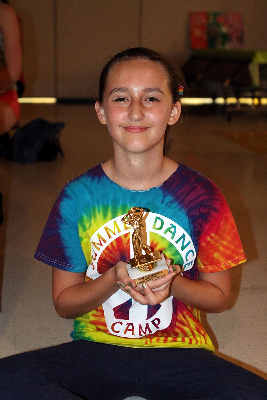 Jana Elsenheimer, 12, holding her two-week award for summer dance camp.