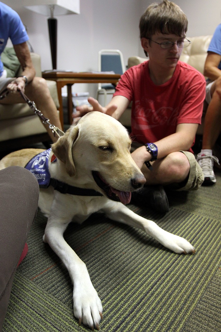 Darby smiles while being given some scratches on the head, Saturday, July 21, during Puppy Love at Southeastern Guide Dogs Sarasota.