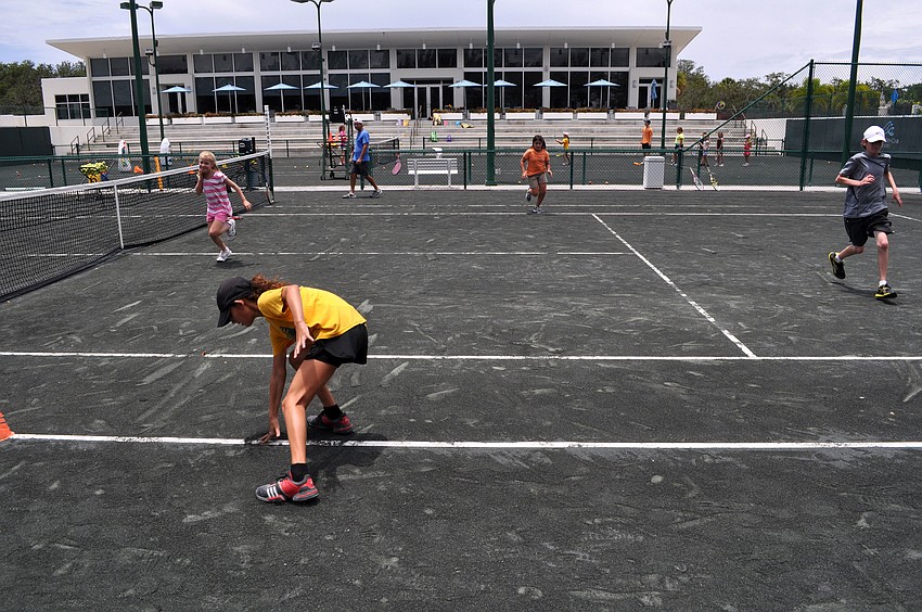 The tennis camp campers run â€œsuicidesâ€ as part of the fitness portion of camp, Monday, July 23.
