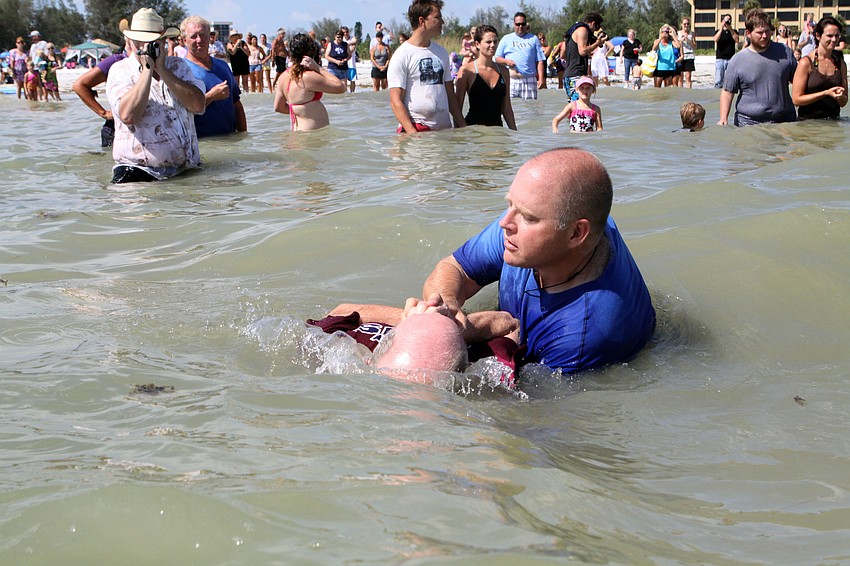 Ed Coil, Discipleship Lead Coach, dunks John Hamel into the Gulf of Mexico during his baptism, Sunday, July 31, on Siesta Key.