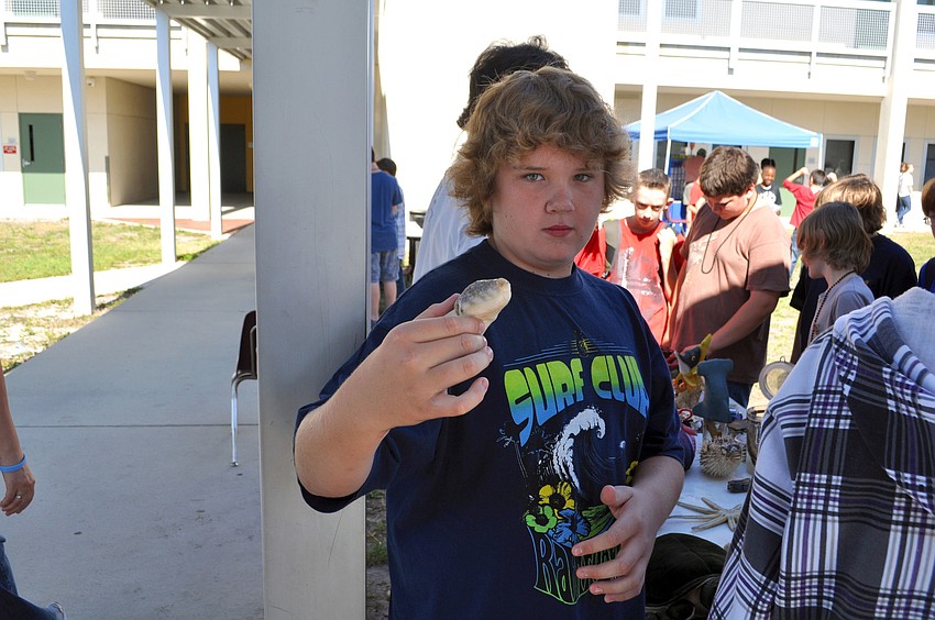Sean Smithburger holds a preserved fish.