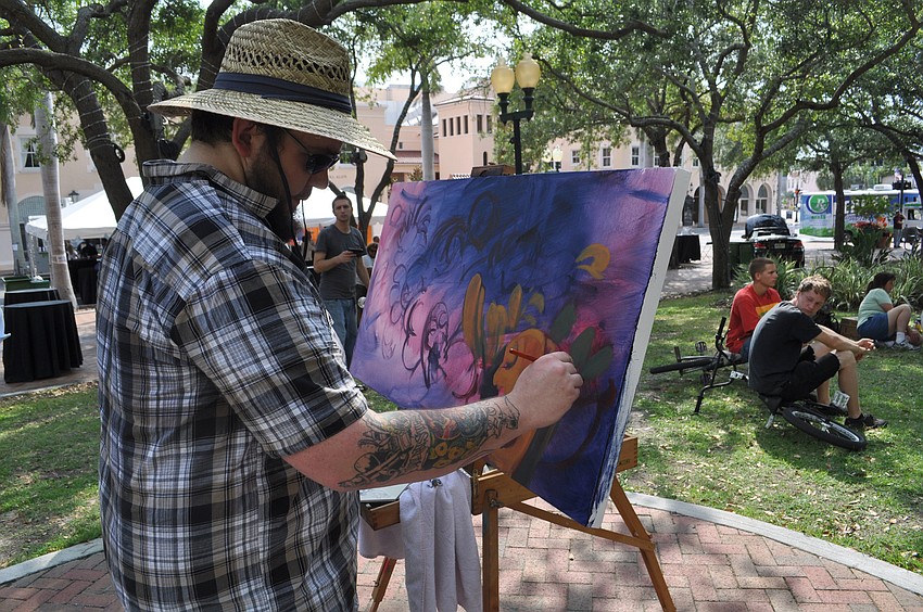 Will Ralston works on a painting.