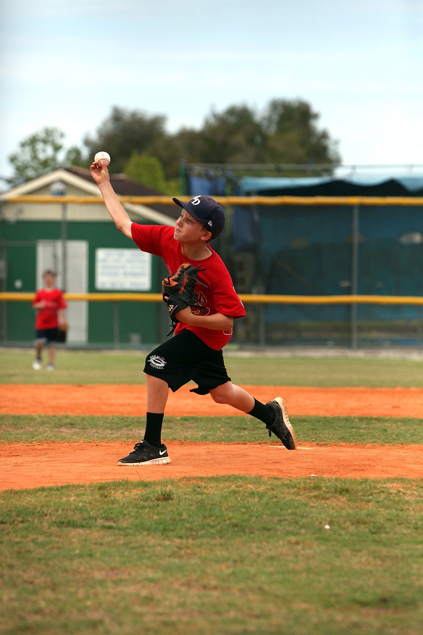 Bryan Gagg pitches towards home plate.