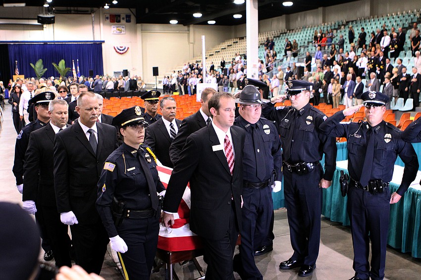 Chief Albert Hogleâ€™s casket is carried out of Robarts Arena following the service.