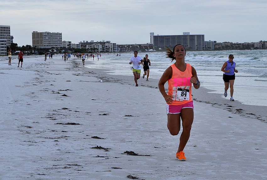Some of the 150 runners make their way towards the finish line.