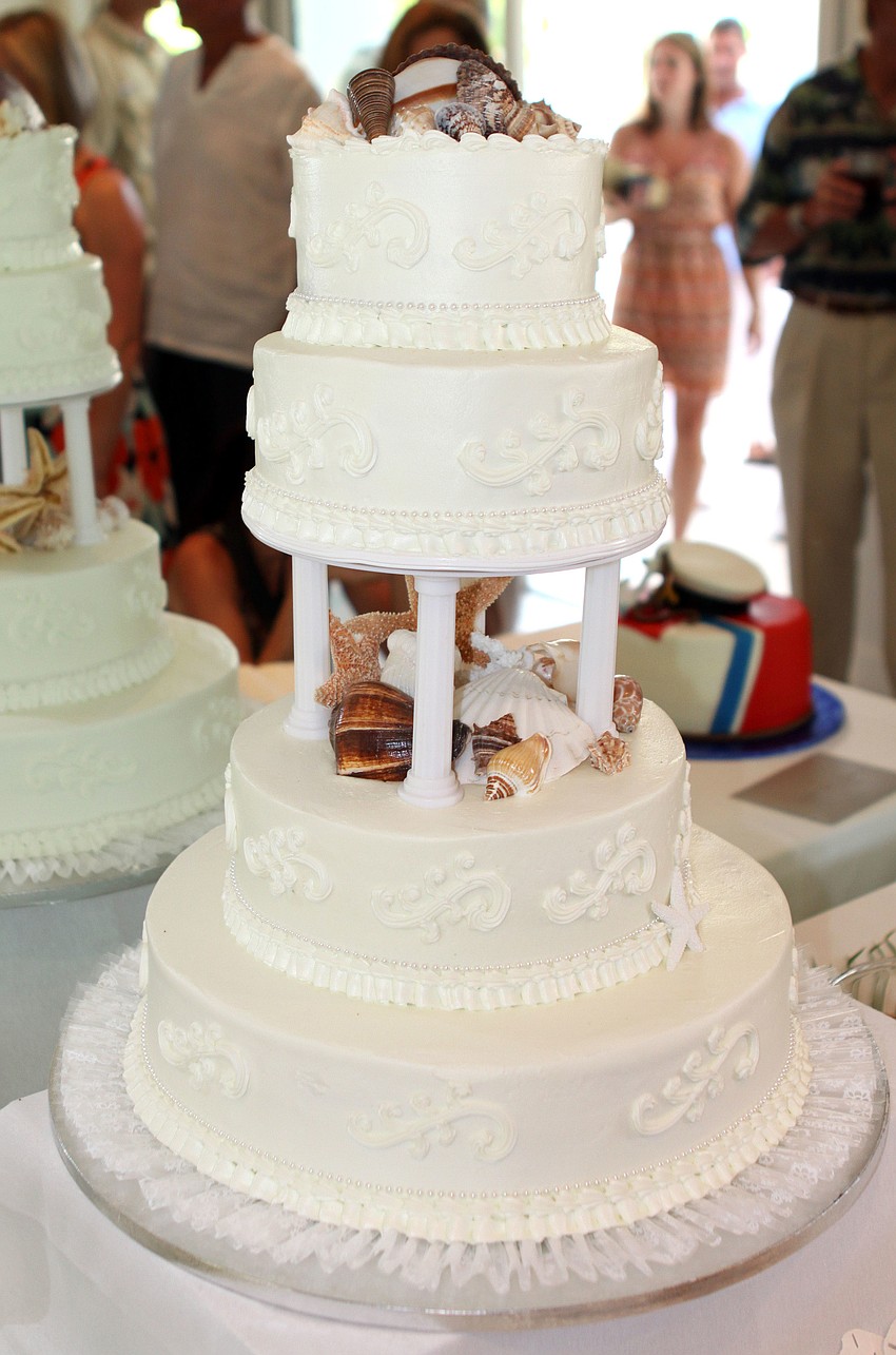 The wedding cake was a beautiful, white, tiered cake decorated with shells, keeping with the beach theme of the wedding.