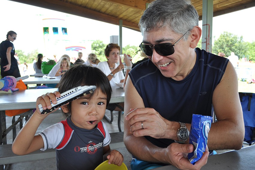 Leo Garza enjoys snacks with his dad, Cesar.