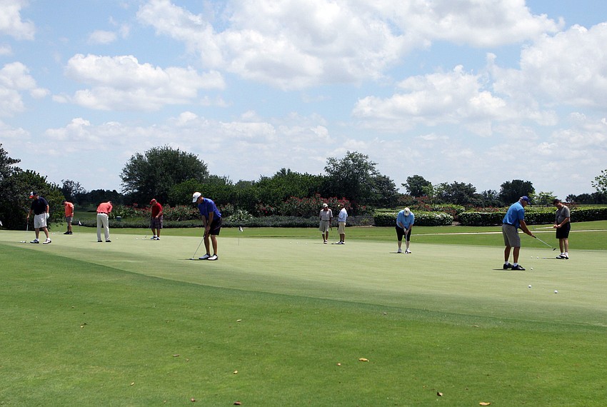 Participants got in some practice on the putting green, Monday, May 7.