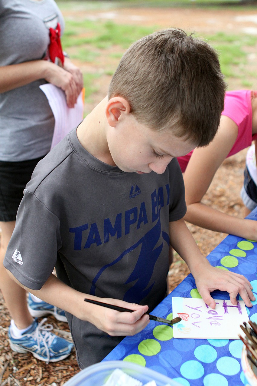 Brayden Lenz, 6, works on a card for his dad.