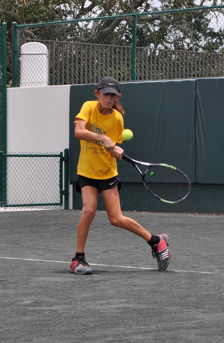 Hadleigh Schwartz, 12, goes to hit a backhand during match play time against Coach Todd Scheck.