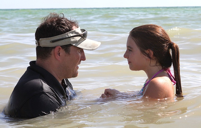 Pastor Craig King talks with his daughter, Avery King, 8