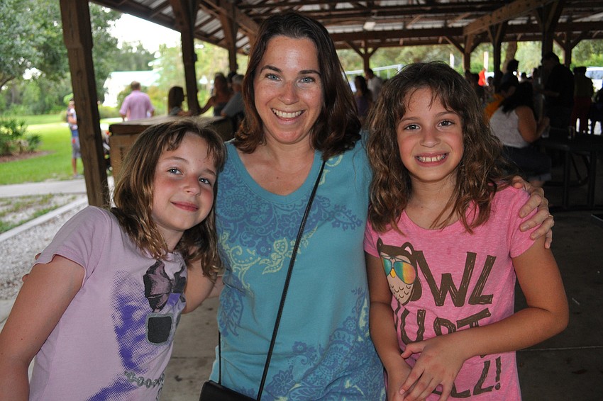 Katie, Sharon and Abby Alcock enjoy dinner outside together.