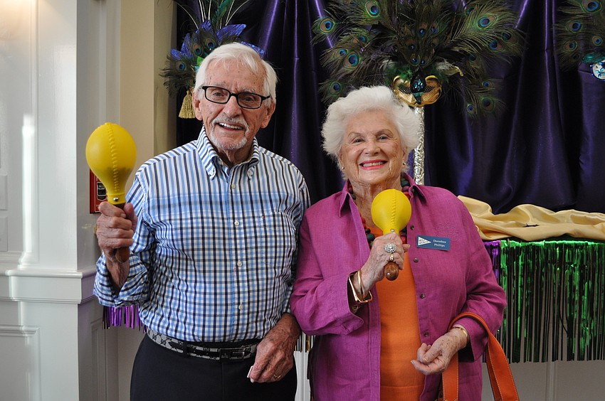 Charles and Dorothea Phillips shake some maracas at Bird Key Yacht Club.