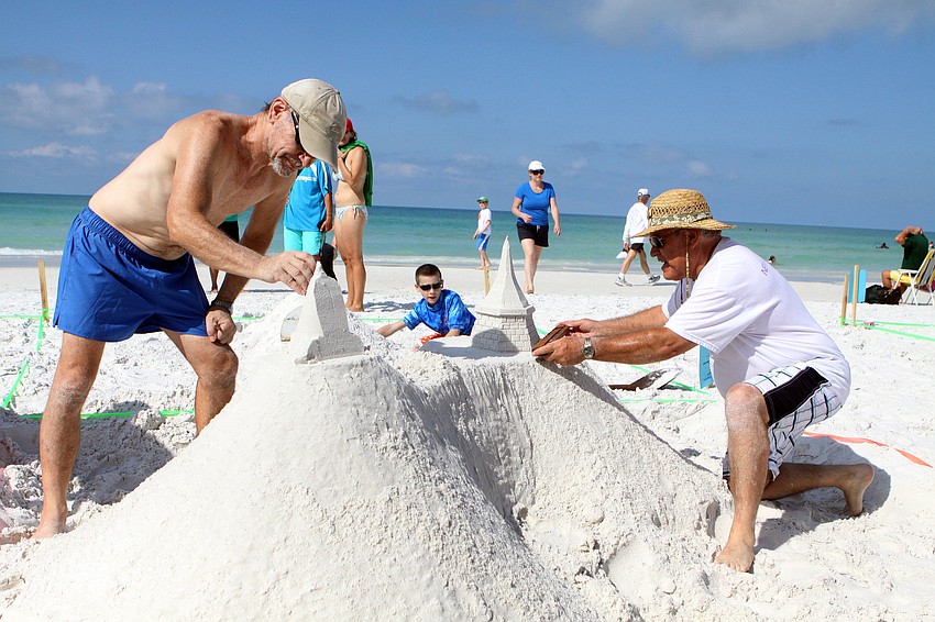 Cliff Richardson and his brother Bud Richardson work together on their piece, Saturday, May 5.