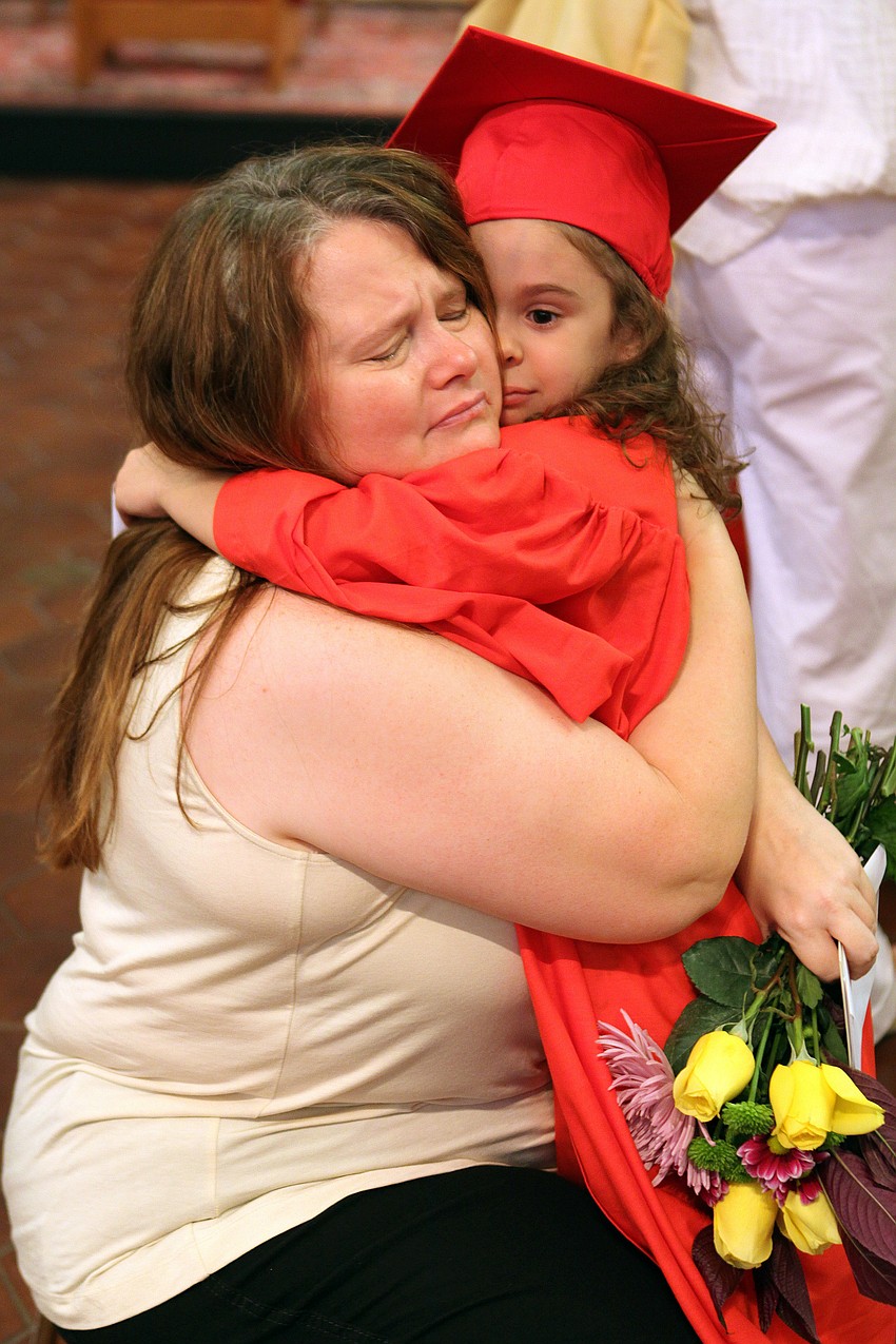 Kat Wors and Giovanna Hansen embrace in an emotional hug after graduation, Friday, June 1.