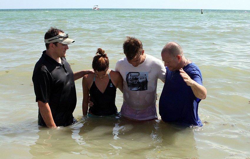 Pastor Craig King and Ed Coil, Discipleship Lead Coach, prepare Caroline and Parker Thurman to be baptized, Sunday, July 30.
