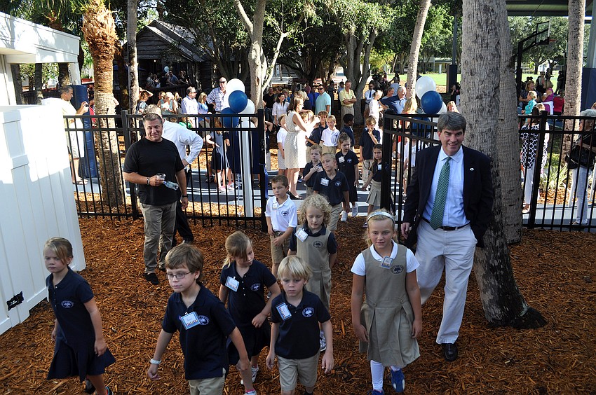 Out-of-Door Academy students run through the gate to the newly renovated lower school playground on the first day of school, Wednesday, Aug. 22, on Siesta Key.