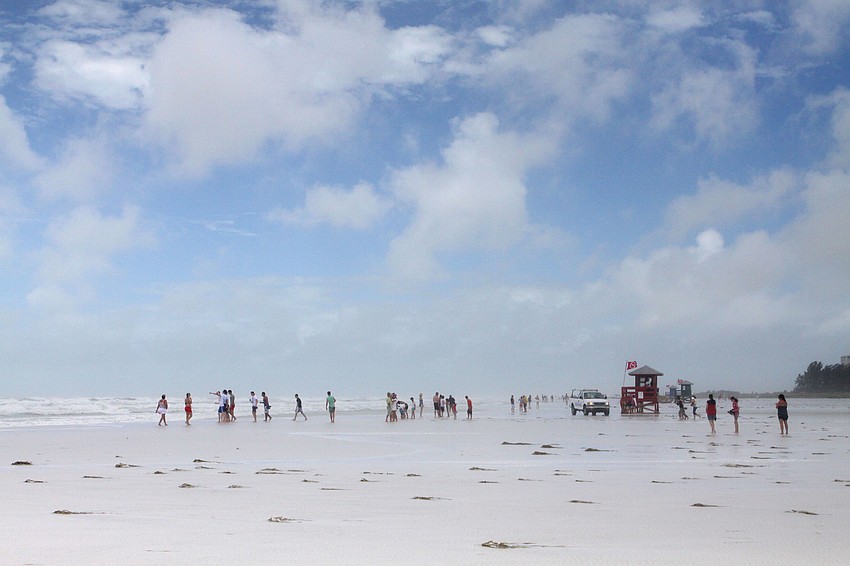 Many people made their way out onto the beach to see the waves on Monday afternoon.
