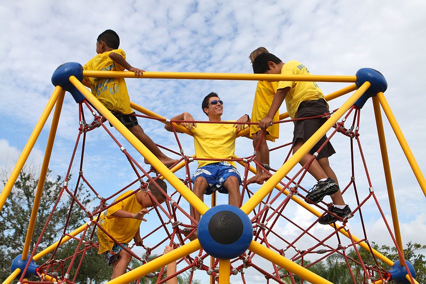Camp counselor Myles Webb, center, hangs out up on the top of the spider web with Thomas Garcia, 6, Cole, 7, Sage Scrimle, 7, and Matthew Garcia, 10, Wednesday, July 18, out at Central Park during Bible Baptist Summer Camp.