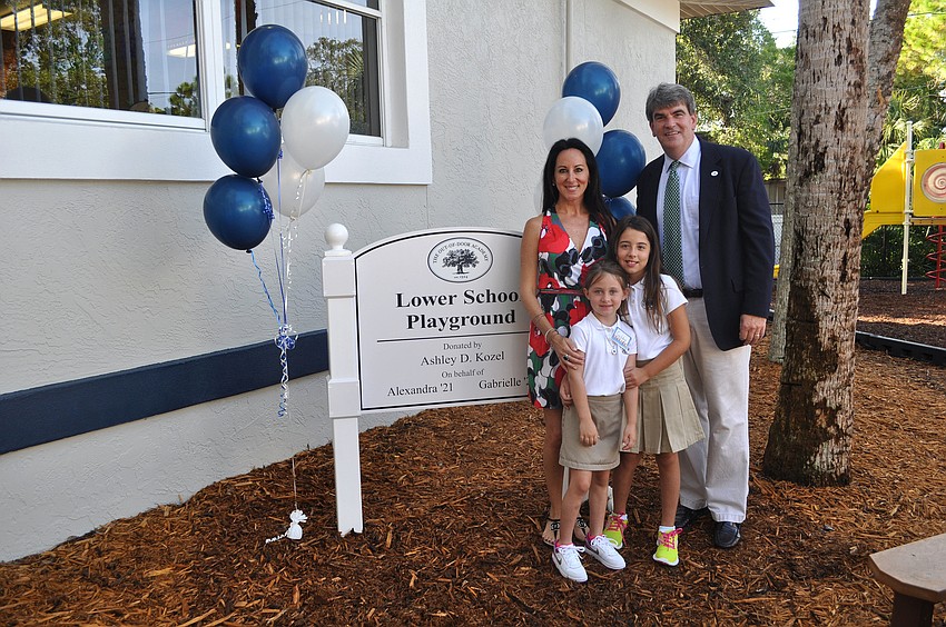 Ashley D. Kozel poses with Head Master David Mahler and her children, Gabby, 6, and Lexie, 9. The Kozel family donated money toward new playground equipment for the lower school.
