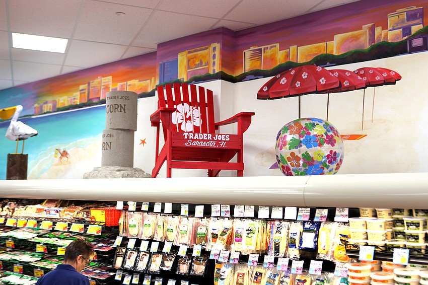 Trader Joeâ€™s made sure to add some Sarasota flair to their displays including this one featuring an Adirondack chair with a hibiscus and the words â€œTrader Joeâ€™s Sarasota, FLâ€, a beach ball and a beach scene painted on the wall.