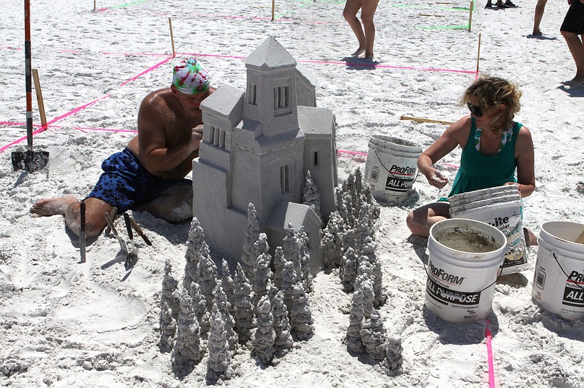 Ken Shields and Mollie Morgan work on their piece, â€œCastle by the Seaâ€, Saturday, May 5.