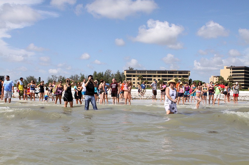 Friends and family watched from the shoreline as their loved ones were baptized in the Gulf of Mexico, Sunday, July 30.