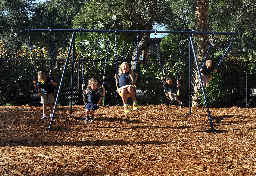 Students have fun on the swings.
