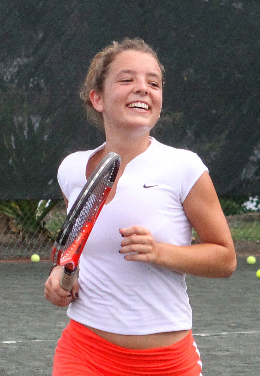 Constance Miller, 16, smiles as she makes her way to the other side of the court during a game of 