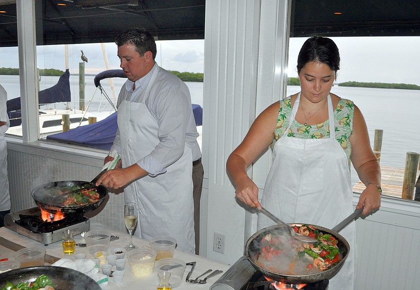 Paul and Theresa Kauffman have fun flambÃ©ing during the Taste of the World Interactive Dinner, Friday, Aug. 17, at Pattigeorgeâ€™s.