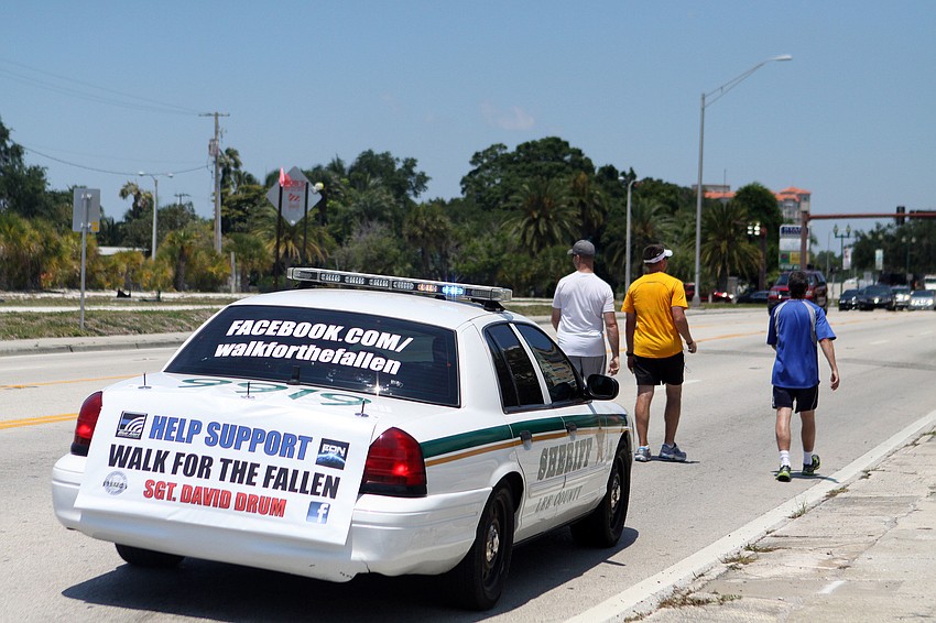 The cop car following the men had the Facebook page address posted to the back of the car so that people can learn more about Sgt. David Drum's walk and Concerns of Police Survivors (COPS).
