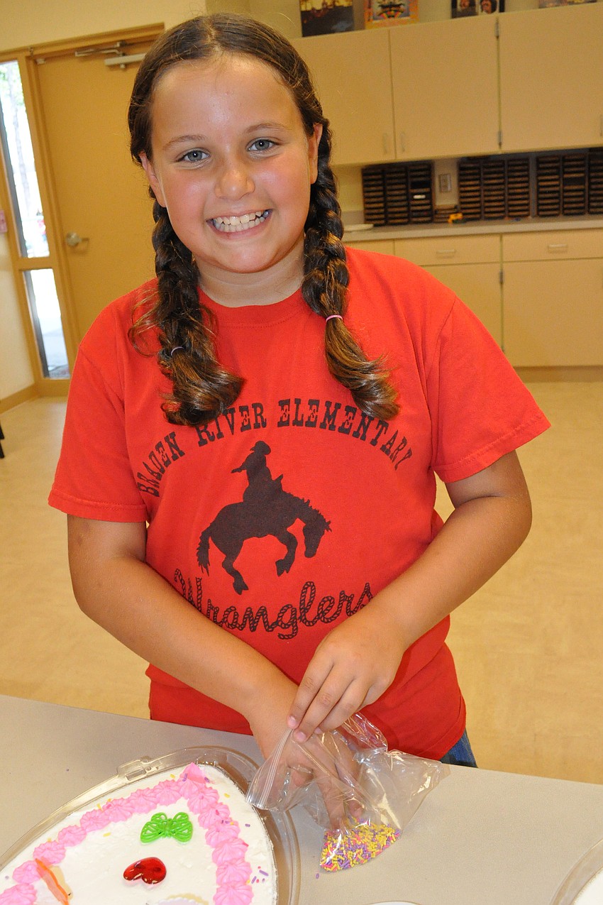 Jordan Cangro, 9, is eager to give the cake to her mom.