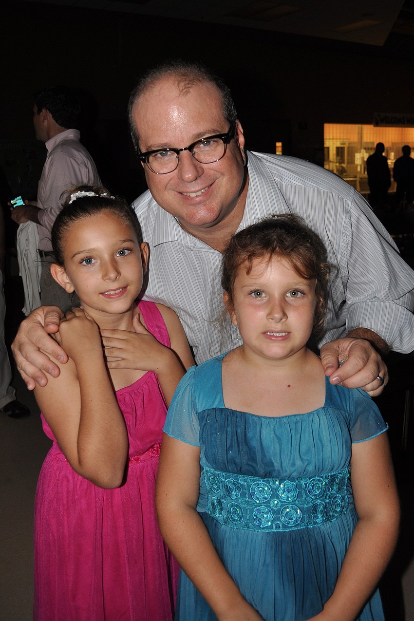 Mike Fults, center, with his daughters, Carly, left, and Casey, right
