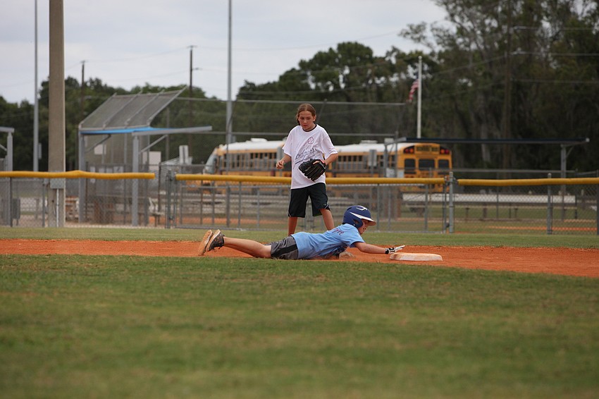 Austin Apap Bologna dives back towards second base as Hailey Rosenhaus looks on, Friday, May 4, during Ashtonâ€™s World Series Day.