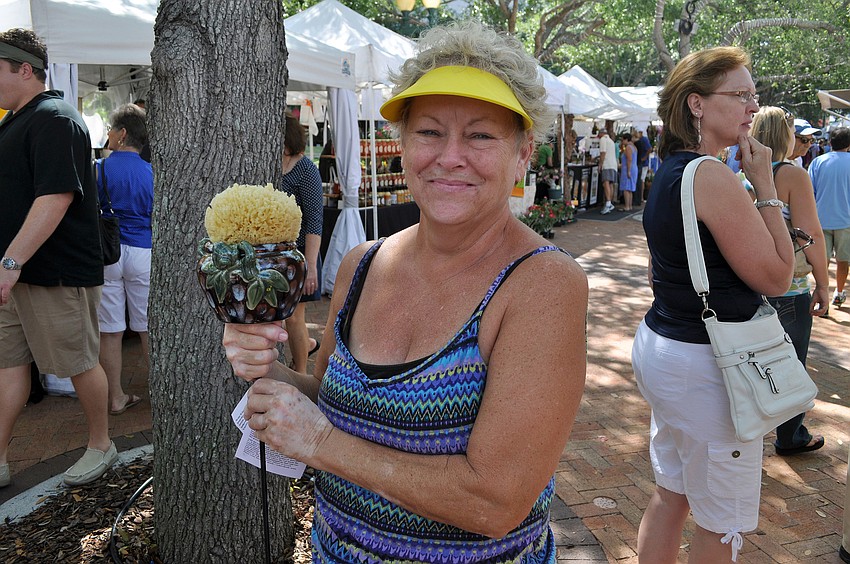 Kathleen Fitzgerald shows off her new decorative garden piece.