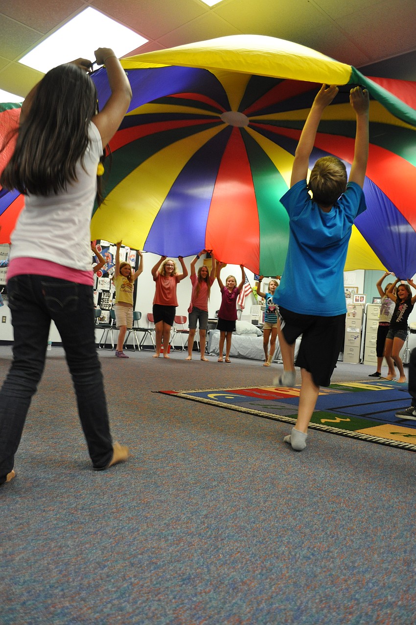 Students used a parachute during one of their musical activities.