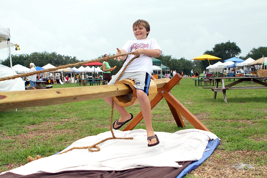 Mickey Bangs, 11, tries to pull himself across while staying on the â€œhorseâ€.