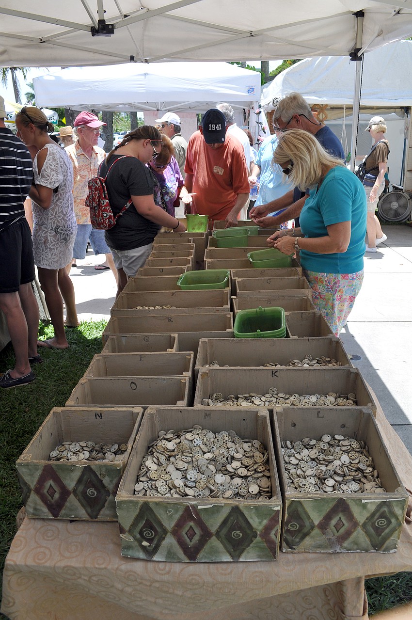 Shoppers look through bins at the craft festival.