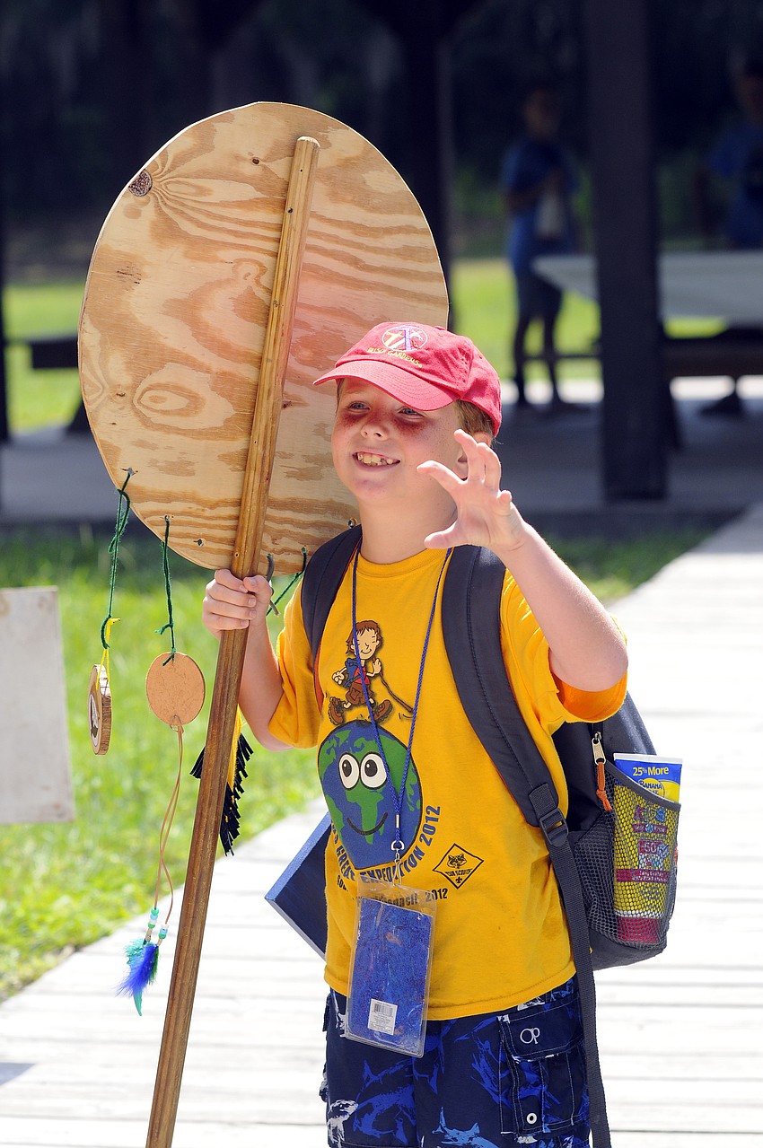 Eight-year-old Erik Ronald proudly carried the totem pole for the python group.