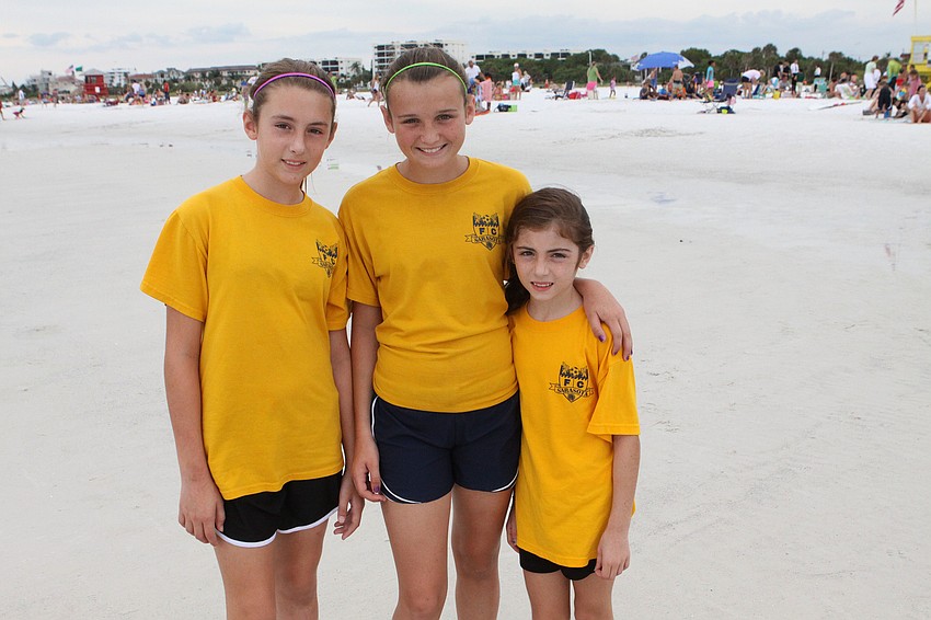 Felicia Cardenas, 12, Erin McGrath, 14, and Mariana Cardenas, 8, pose together before running in the Summer Fun Run, Tuesday, June 19, out on Siesta Key Public Beach.