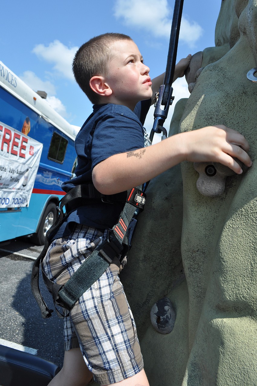Nicholas Lizura, 7, tried out the Within Reach rock-climbing wall.