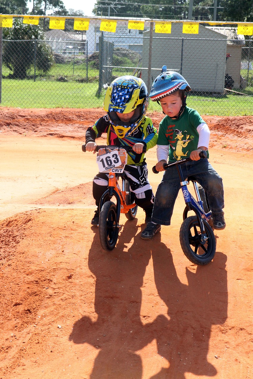 Wyatt Forsyth, 3, and Liam Keltch, 2, try to make their way down a hill on the Strider practice course, Saturday, July 7, at Sarasota BMX.