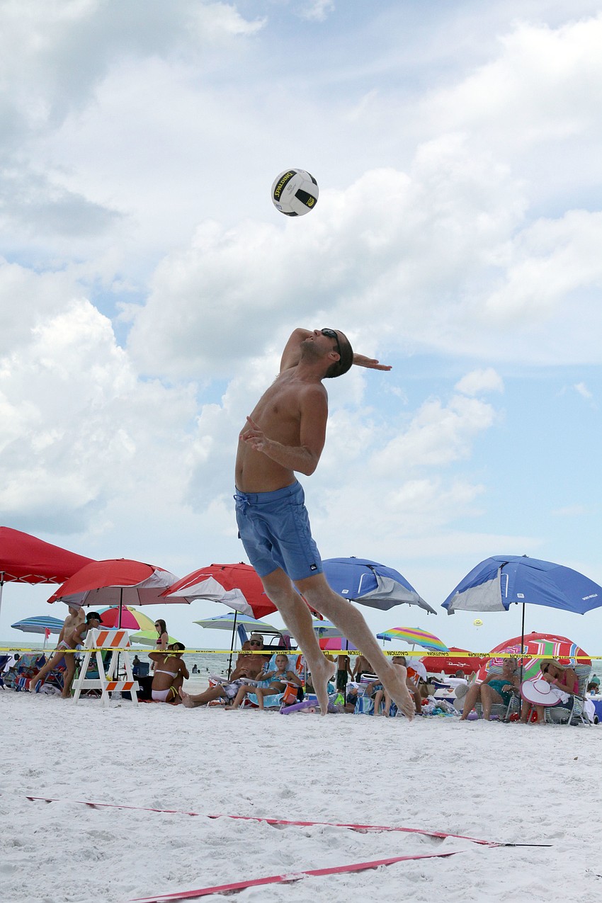 Kent Ammons serves up the ball during a match against the Lunardi brothers, Saturday, July 14, during the Dig the Beach tournament on Siesta Key Beach.
