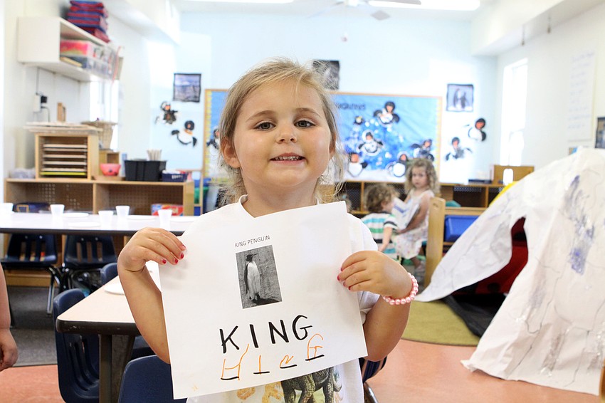 Ari Benson, 3, shows off her writing skills after spelling the word â€œKingâ€ underneath a photo of a King penguin.