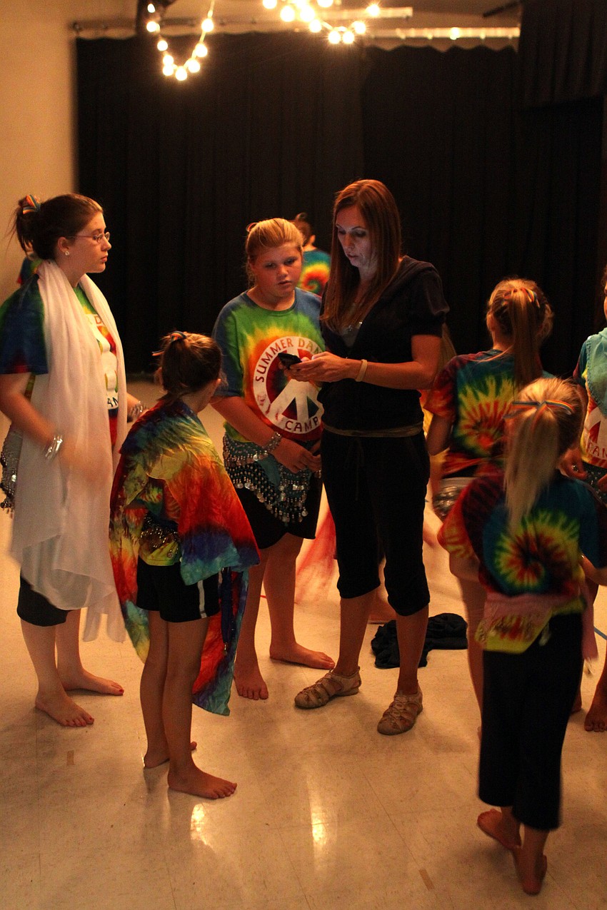 Michele Mercier talks with some of the dancers backstage before the start of the show, Friday, July 12.