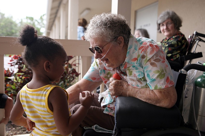 Ashyiah Davis, 2, interacts with Irene Amadio, Tuesday, Aug. 7, at Pines of Sarasota.