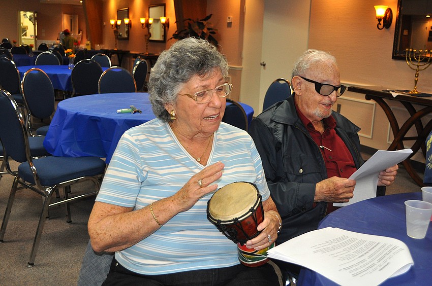 Renee Gold plays one of the many drums and sings along with her husband, Bert, during La La La Havadalah, Aug. 18, at Temple Emanu-El.